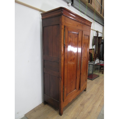 505 - A 19th Century Continental Cherrywood Armoire with moulded top above a pair of panelled doors enclos... 