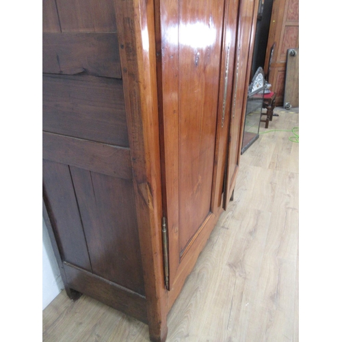 505 - A 19th Century Continental Cherrywood Armoire with moulded top above a pair of panelled doors enclos... 