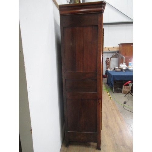 505 - A 19th Century Continental Cherrywood Armoire with moulded top above a pair of panelled doors enclos... 