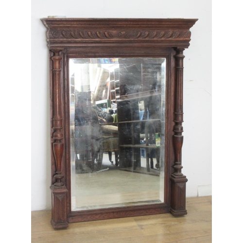 516 - An oak framed Wall Mirror with bevelled plate flanked by fluted and turned columns, 3ft 6in H x 2ft ... 