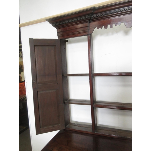 519 - A Georgian mahogany Dresser and Rack with shaped frieze flanked by cupboard doors, the base fitted a... 