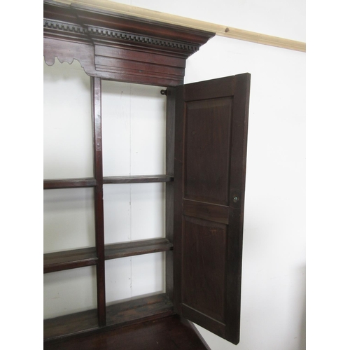 519 - A Georgian mahogany Dresser and Rack with shaped frieze flanked by cupboard doors, the base fitted a... 