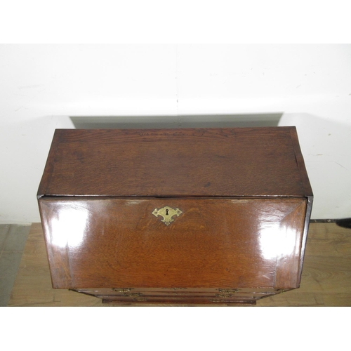 522 - An 18th Century oak Bureau of small proportions with fitted interior above three drawers on bracket ... 