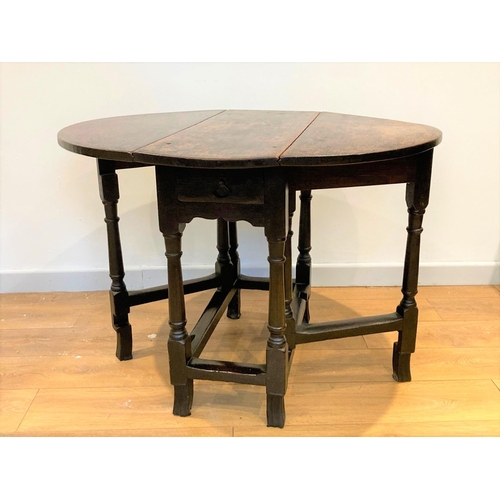 525 - A William & Mary c1680 oak Gateleg Table, fitted single end drawer and mounted upon barrel turned su... 