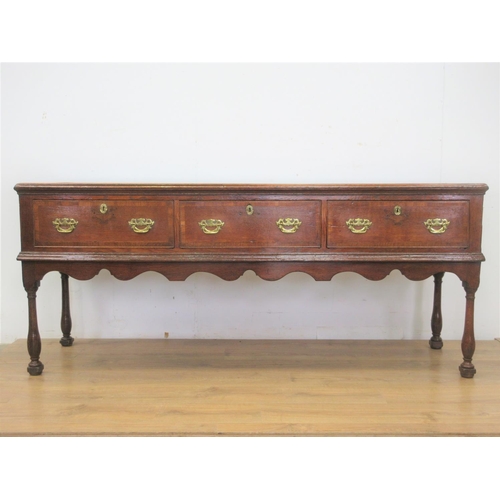 526 - An 18th Century oak Dresser Base with moulded top, three frieze drawers above a shaped frieze on bal... 