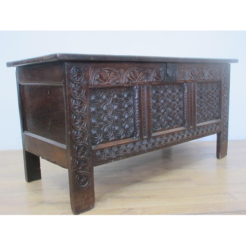 527 - A 17th Century carved oak Coffer, the panelled lid above a lunette frieze and three scroll carved pa... 