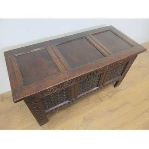 527 - A 17th Century carved oak Coffer, the panelled lid above a lunette frieze and three scroll carved pa... 