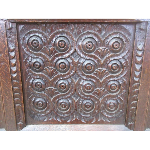 527 - A 17th Century carved oak Coffer, the panelled lid above a lunette frieze and three scroll carved pa... 