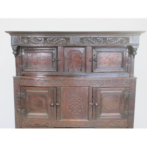 528 - A primarily 17th Century oak Deuddarn with carved frieze dated 1563 with serpent decoration above a ... 