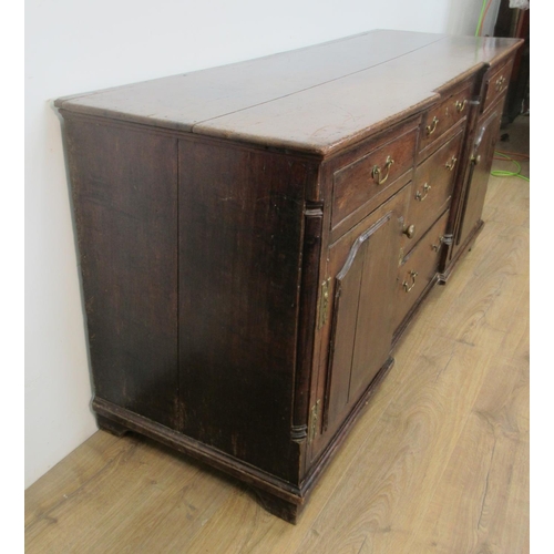 534 - An 18th Century oak inverted breakfront Dresser Base fitted five drawers and pair of raised panelled... 