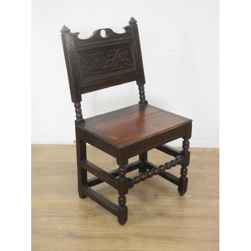 542 - A 17th Century oak Side Chair with shaped top rail, leafage scroll carved panelled back, solid seat ... 