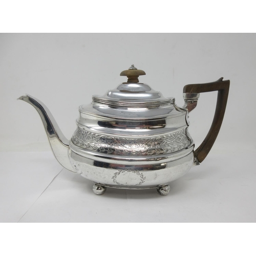 9 - A George III silver boat shape Teapot with leafage engraved frieze and vacant cartouche on ball feet... 