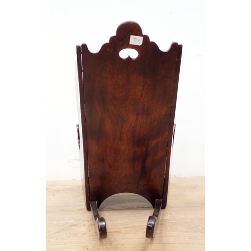 466 - An antique child's Rocking Chair in fruitwood having shaped surmount and sides, solid seat and pierc... 