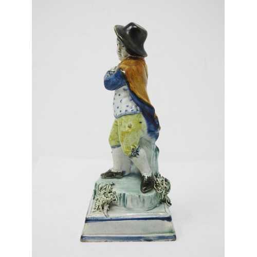 278 - An early 19th Century Prattware figure of 'Winter', wearing hat and cloak, on encrusted square stepp... 