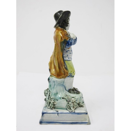 278 - An early 19th Century Prattware figure of 'Winter', wearing hat and cloak, on encrusted square stepp... 