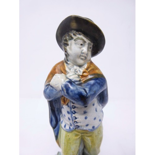 278 - An early 19th Century Prattware figure of 'Winter', wearing hat and cloak, on encrusted square stepp... 