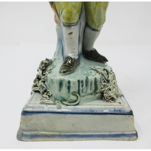 278 - An early 19th Century Prattware figure of 'Winter', wearing hat and cloak, on encrusted square stepp... 