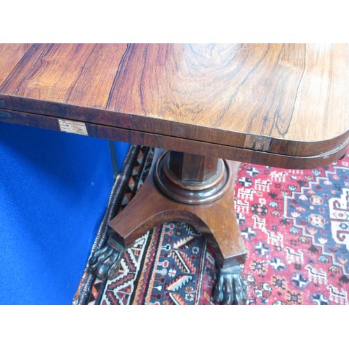 477 - A 19th Century rosewood Card Table with fold-over top on octagonal column, the platform base with ca... 