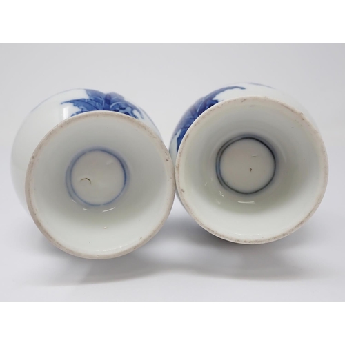 319 - A pair of 19th Century Chinese blue and white Vases of baluster form, decorated figures in a landsca... 