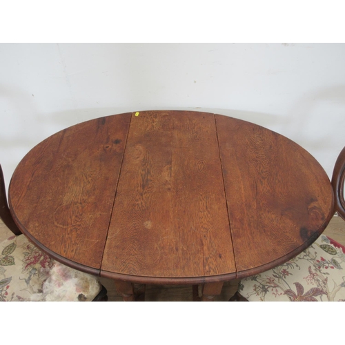 124 - An oak gateleg Table and a pair of Victorian mahogany balloon back Dining Chairs