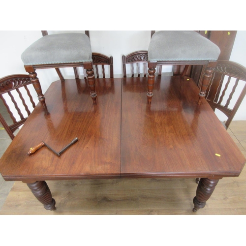 132 - A Victorian walnut extending Dining Table with three spare leaves mounted upon turned and fluted sup... 