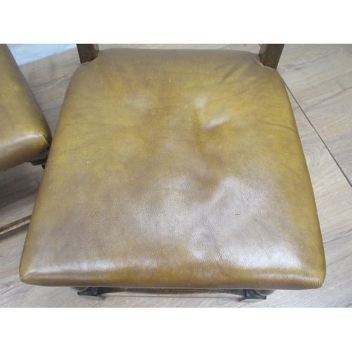 369 - A set of four leather effect covered oak Dining Chairs