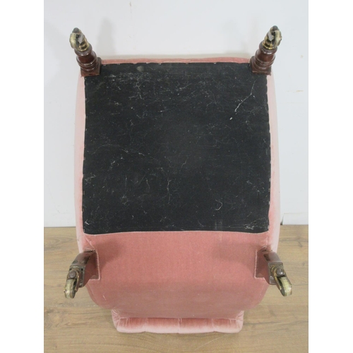 377 - A 19th Century pink upholstered button back Nursing Chair on turned front supports and casters, stam... 