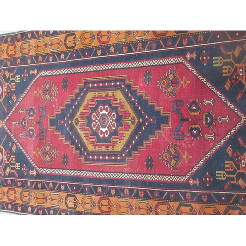 402 - A woollen red ground Rug with styilised floral decoration and brown border 7ft Lx 3ft 6in W approx