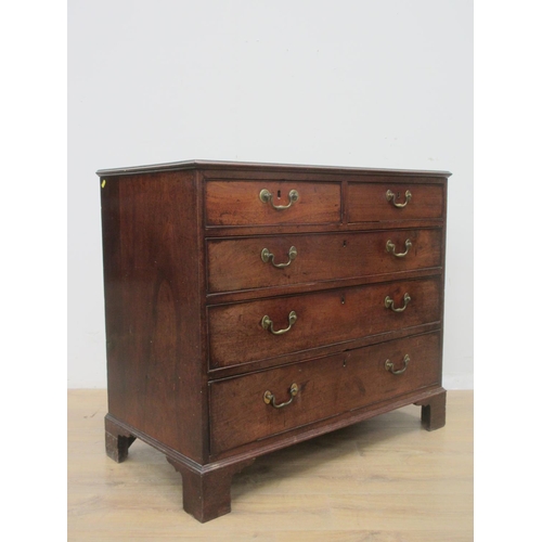 406 - A George III mahogany Chest of two short and three long drawers with moulded top mounted upon ogee b... 