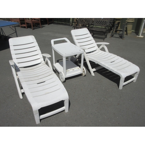 483 - A garden Swing Seat two white plastic Sun Loungers and a Table