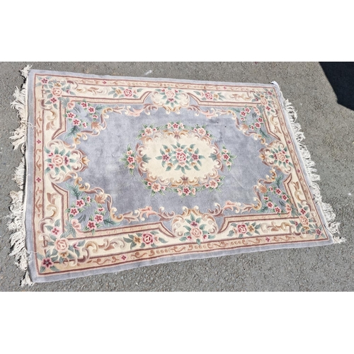 5 - A Chinese blue Rug with cream floral central oval within tramline border 9ft 4in L x 6ft W