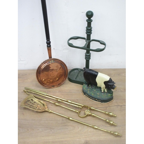 505 - An antique Warming Pan, a set of brass Fire Irons, a Stick Stand and a Saddleback Pig Door Stop