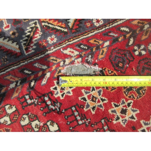 1 - A red ground woollen Rug A/F 8ft6in L x 5ft 2in W approx