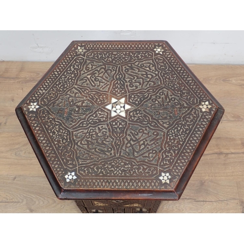 11 - A North African carved hardwood and mother of pearl inlaid hexagonal Table 1ft 10in W x 1ft 9in H