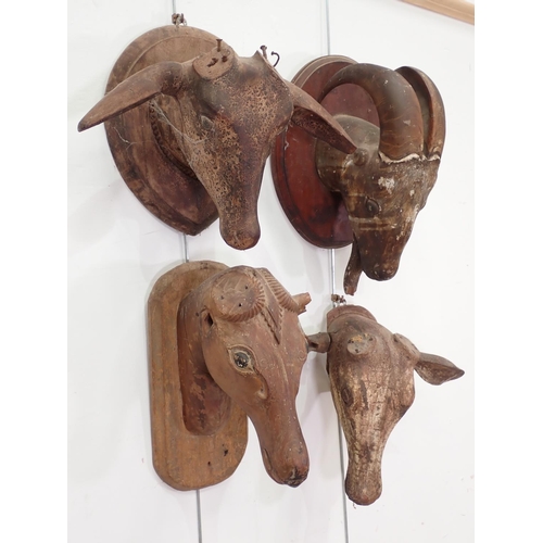 121 - Four old carved animal Heads, three on shields