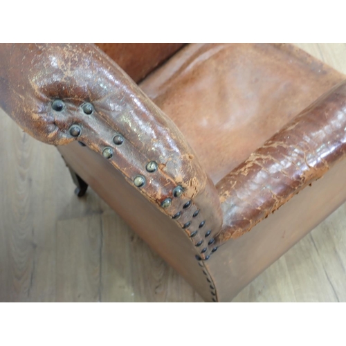 128 - An Edwardian leather upholstered Armchair mounted upon square cut supports and casters 2ft 8in H x 2... 