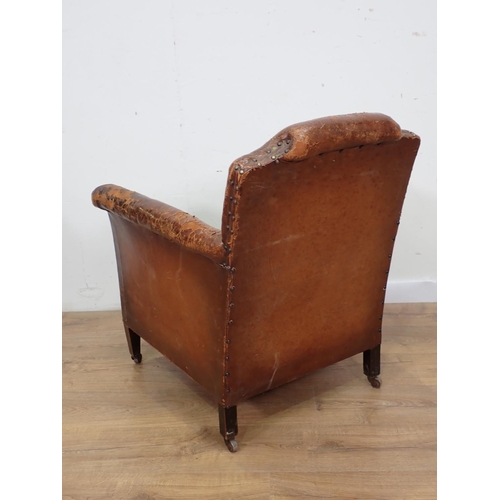 128 - An Edwardian leather upholstered Armchair mounted upon square cut supports and casters 2ft 8in H x 2... 