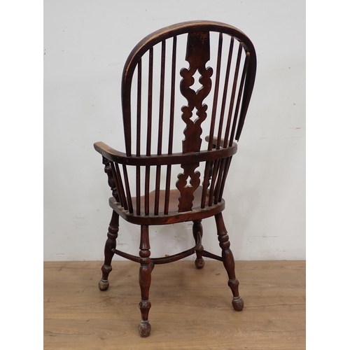 13 - A 19th Century ash and elm Windsor Armchair with pierced splat back on turned supports united by cri... 