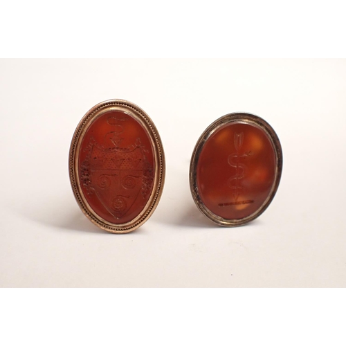 169 - Two Intaglio Seal Fobs the carnelian engraved crest and serpent with arrow in yellow metal