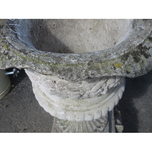 313 - A pair of moulded concrete Urns on plinths, 3ft 1in H