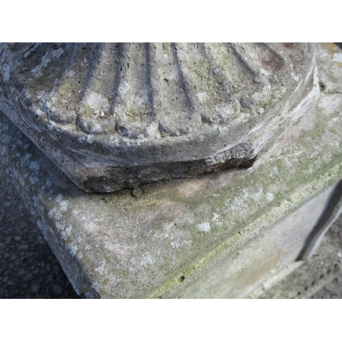 313 - A pair of moulded concrete Urns on plinths, 3ft 1in H