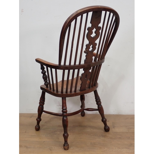 39 - A 19th Century ash Windsor Armchair mounted upon turned supports united by crinoline stretcher 3ft 8... 