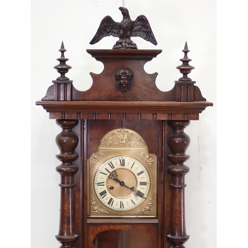 391 - A walnut cased American Wall Clock with eagle surmount 3ft 10in