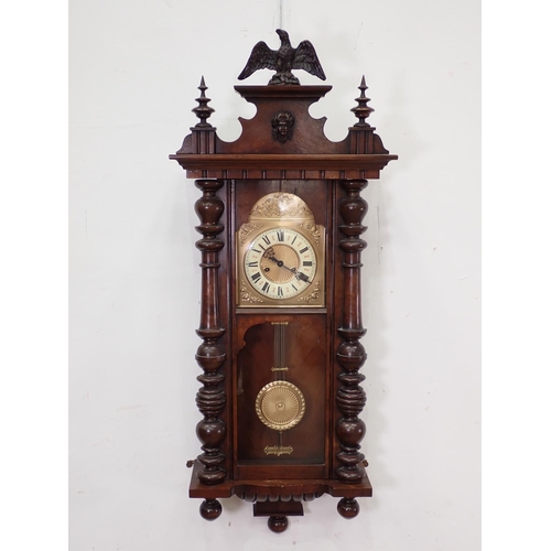 391 - A walnut cased American Wall Clock with eagle surmount 3ft 10in