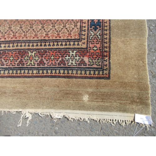 398 - A bordered Oriental Rug with beige surround and pink central ground, 10ft 6in x 5ft