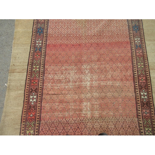 398 - A bordered Oriental Rug with beige surround and pink central ground, 10ft 6in x 5ft