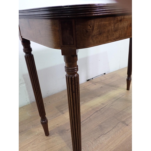 40 - A 19th Century mahogany and boxwood strung fold over Tea Table mounted upon fluted tapering supports... 