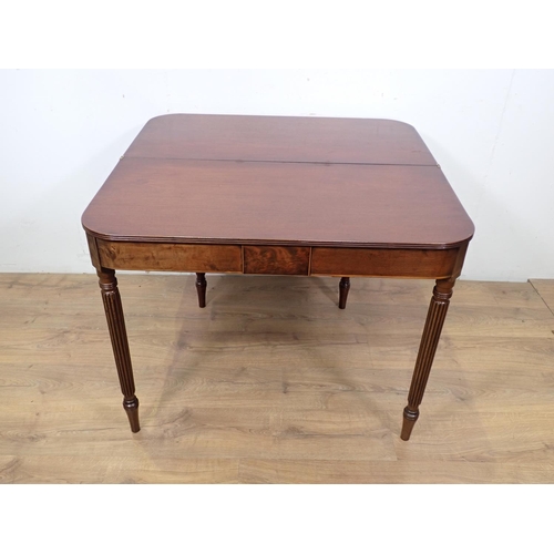 40 - A 19th Century mahogany and boxwood strung fold over Tea Table mounted upon fluted tapering supports... 