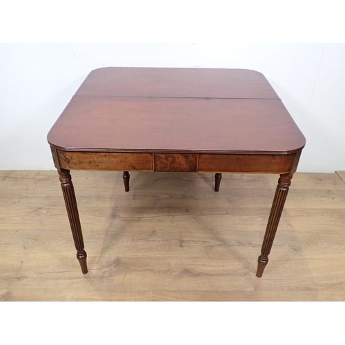 40 - A 19th Century mahogany and boxwood strung fold over Tea Table mounted upon fluted tapering supports... 