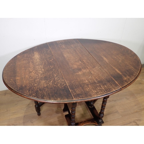 412 - A 20th Century oak gateleg Table on turned supports and bun feet 3ft 8in W x 2ft 5in H